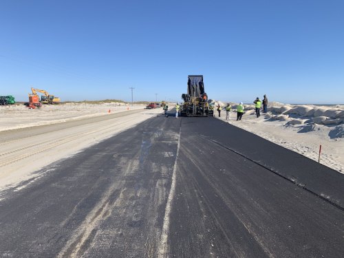 Crews put the finishing paving touches on NC Highway 12 on Ocracoke Wednesday. The road is scheduled to reopen to all traffic Thursday.